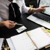 Business owner working at a desk with a laptop and notepad